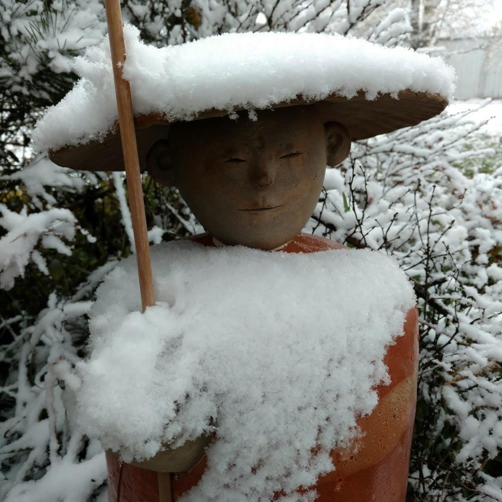 Snow covered statue made by Anne Maraviglia