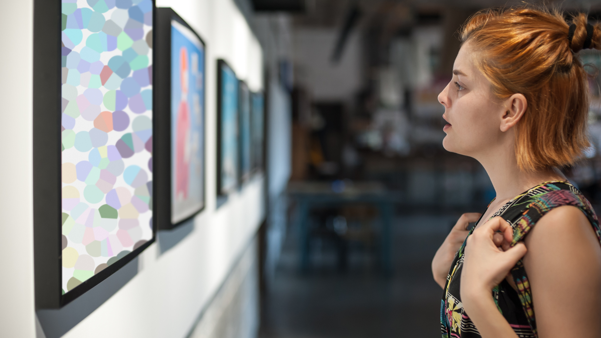 Female gallery visitor enjoying artwork at Artem Pop Up Gallery