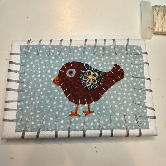 Fabric pouch with a bird design on a polka dot background from an art workshop with Erin Kennealy